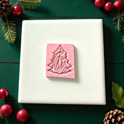 Pink nativity tree clay imprint on square clay slab with festive ornaments