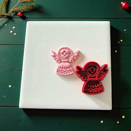 Pink and red angel cutters side by side on white tile