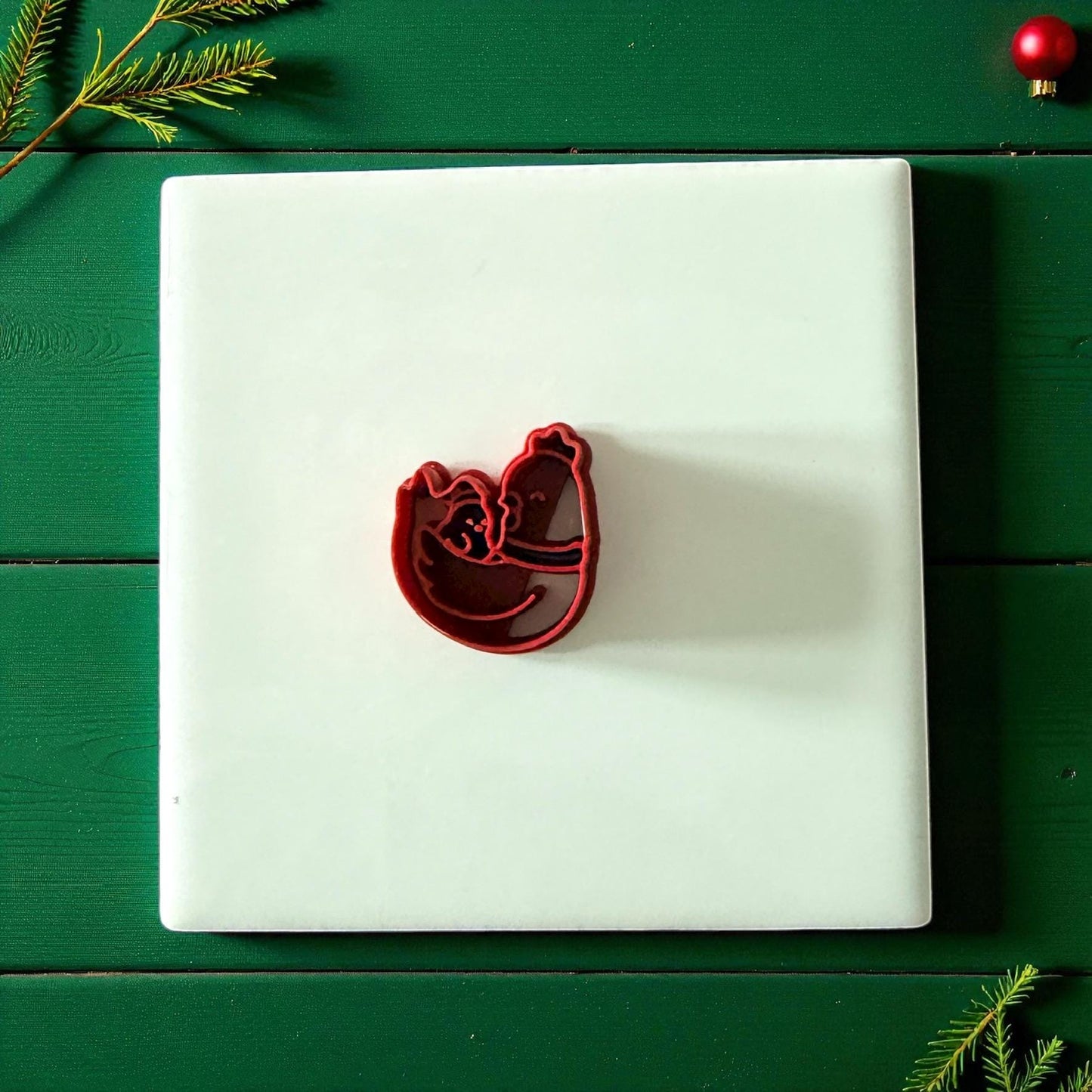 Chicken family clay cutter centered on white tile with green background