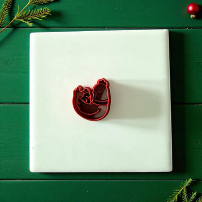 Chicken family clay cutter centered on white tile with green background