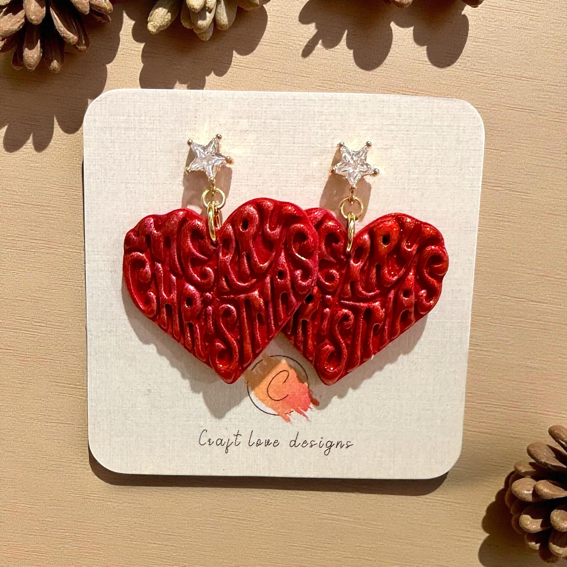 Red clay earrings with Merry Christmas heart design and gold star studs