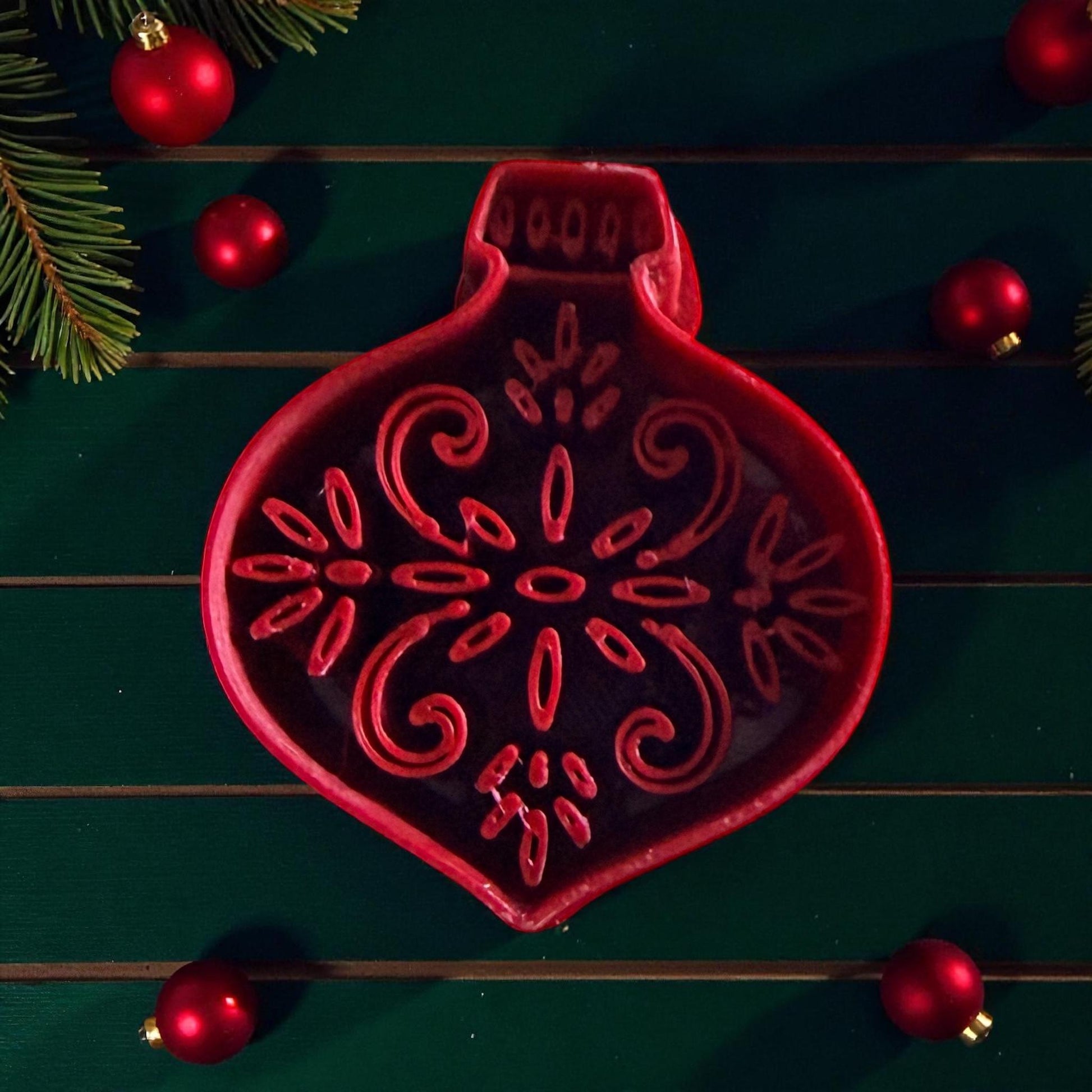 Close-up of red ornament cutter with detailed snowflake pattern