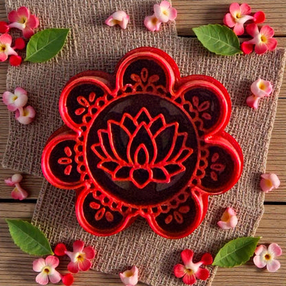 Red lotus mandala polymer clay cutter with floral pattern surrounded by flowers and leaves