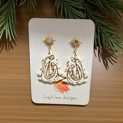 Nativity tree polymer clay earrings with gold starburst studs on display card