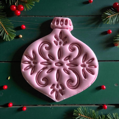 Close-up of pink ornament clay piece showing intricate snowflake details
