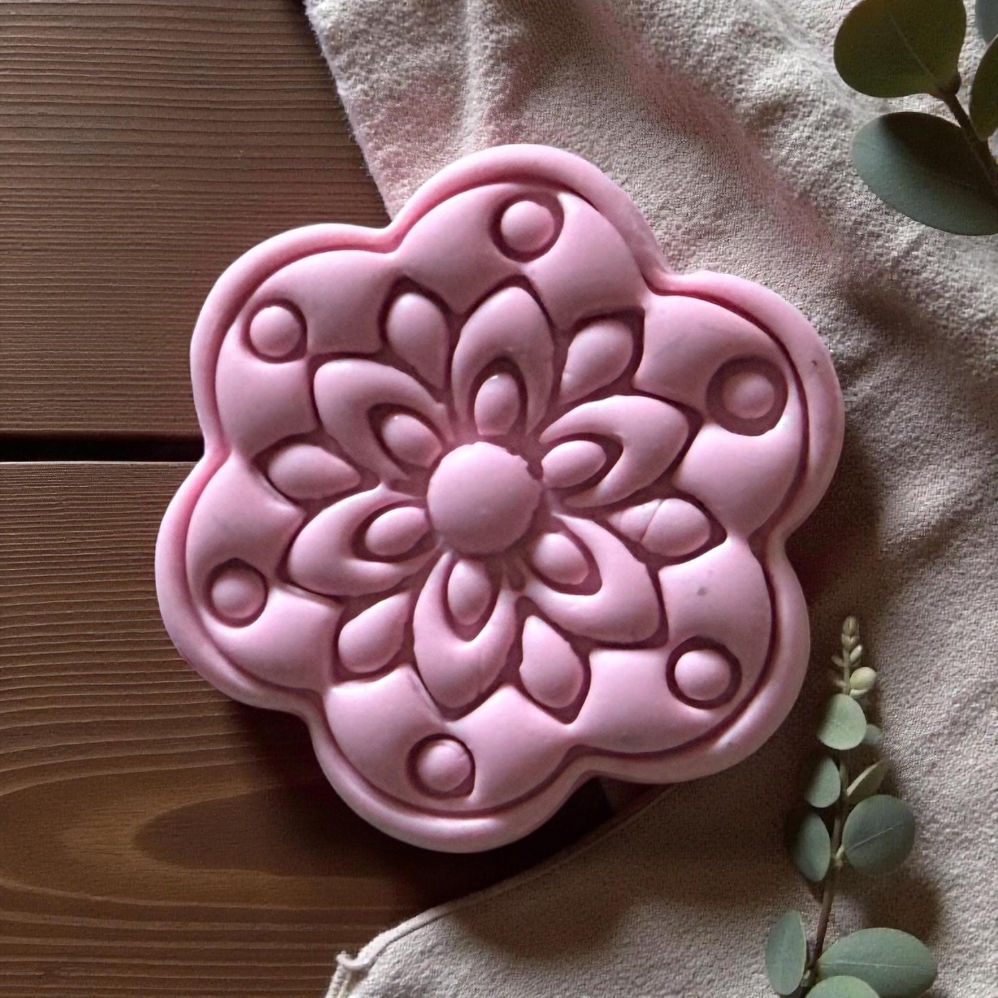 Close-up of pink flower clay piece showing layered petal details