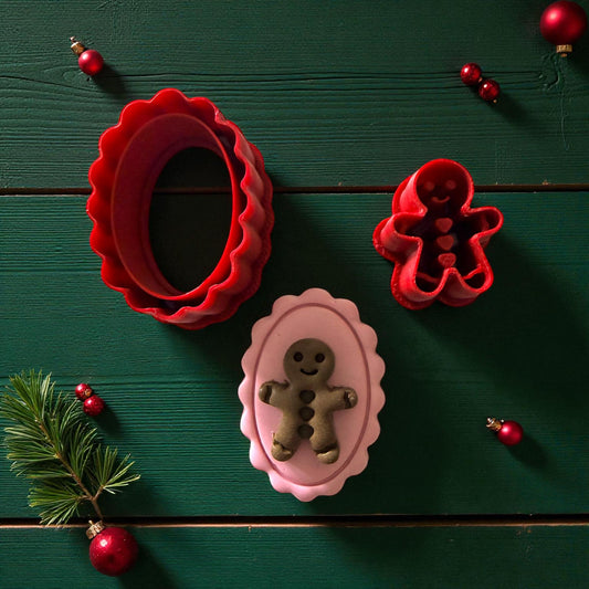 Red cutters with pink clay cameo featuring green gingerbread design