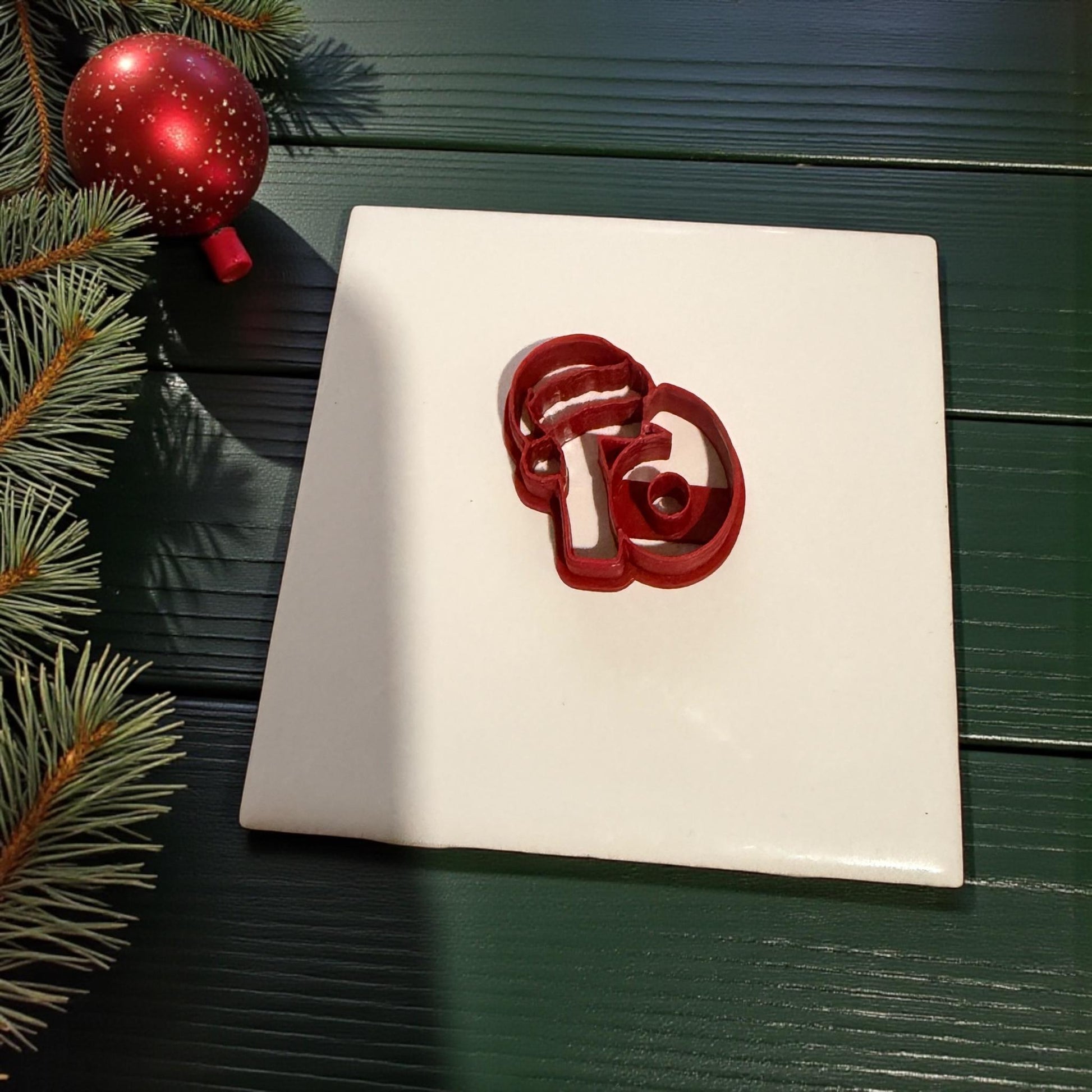 single red santa hat 67 cutter with holiday greenery