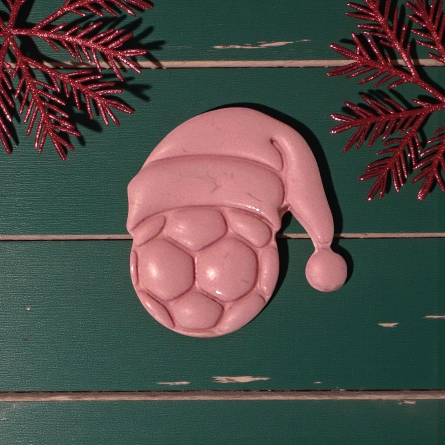 closeup of pink soccer santa hat clay piece