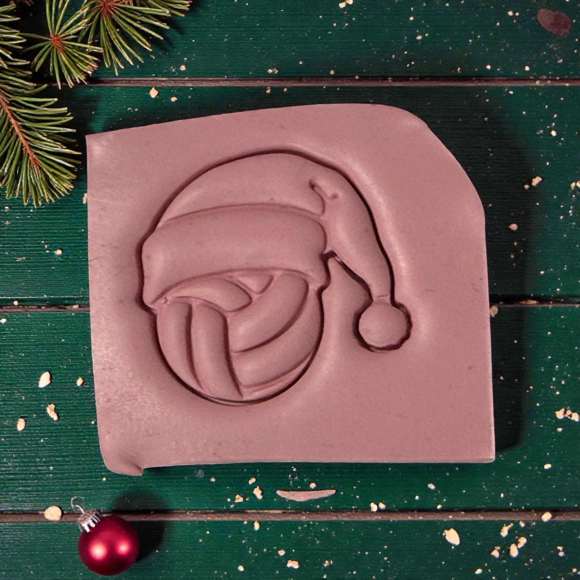 pink volleyball santa clay impression on green wood closeup