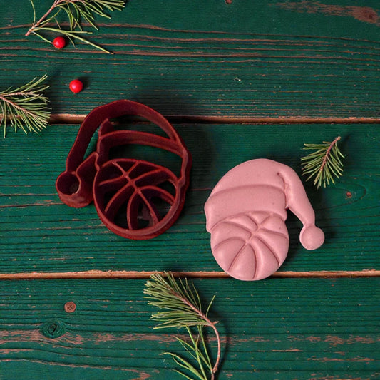 basketball santa cutter and clay piece on green wood