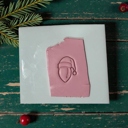 football santa impression on tile with greenery