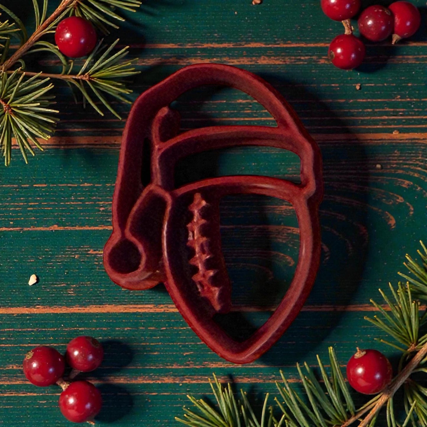 football santa hat polymer clay cutter on wooden green table