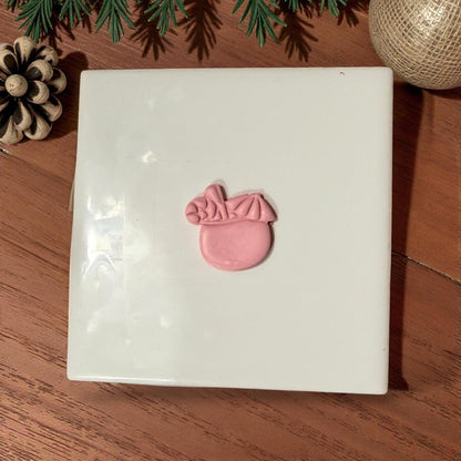 pink clay coconut drink centered on white tile