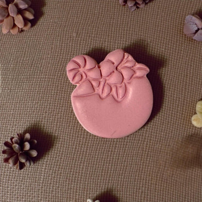 clay drink shape surrounded by mini pinecones