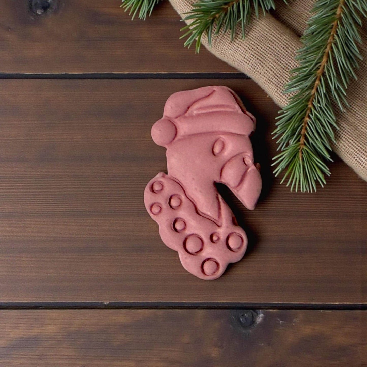 “Pink flamingo Christmas clay piece on wooden background”