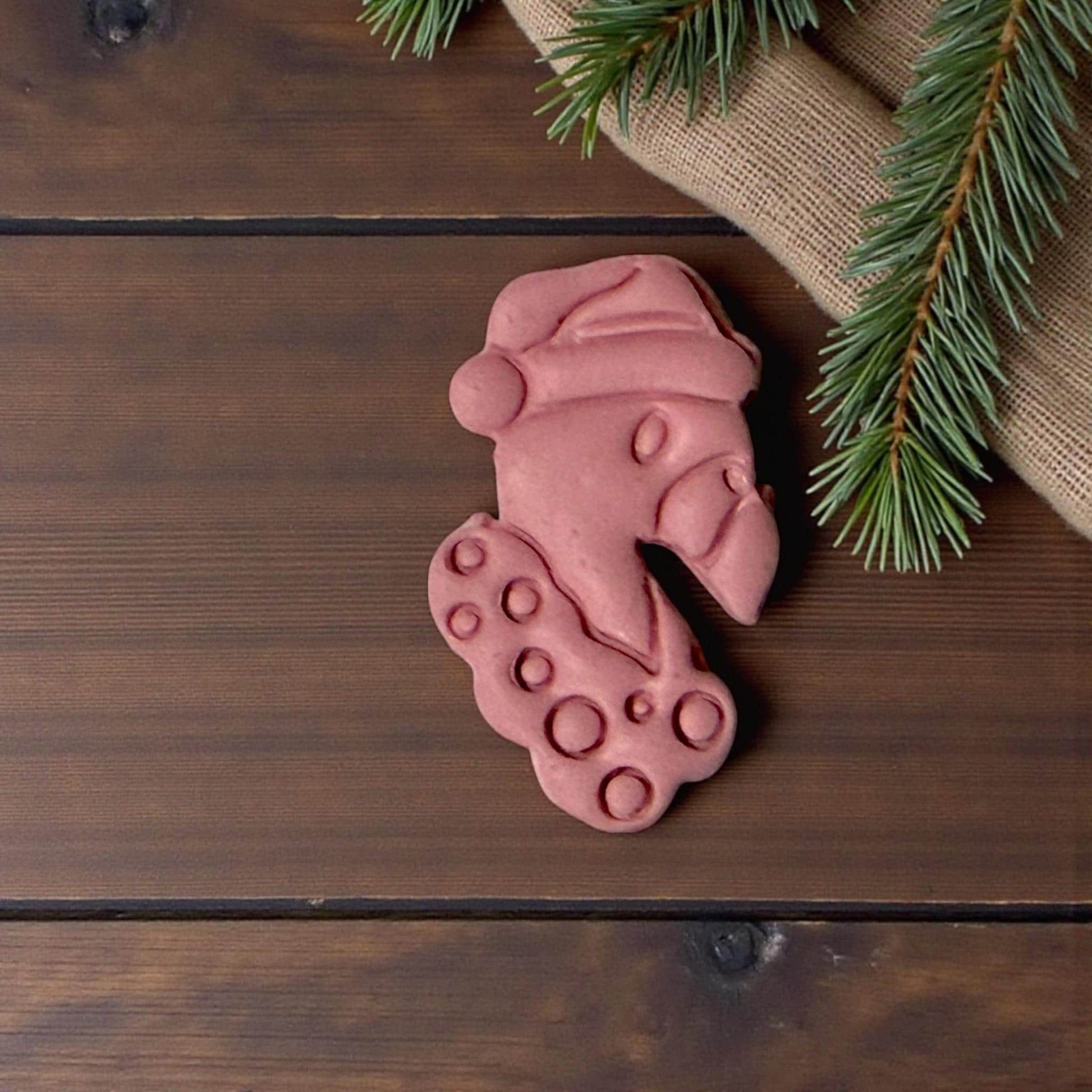 “Pink flamingo Christmas clay piece on wooden background”