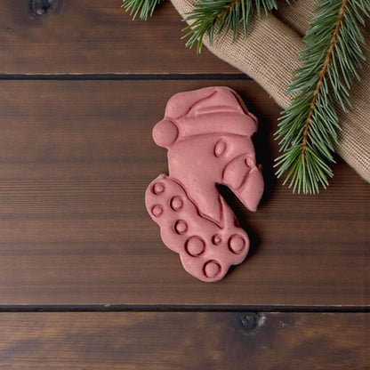 “Pink flamingo Christmas clay piece on wooden background”