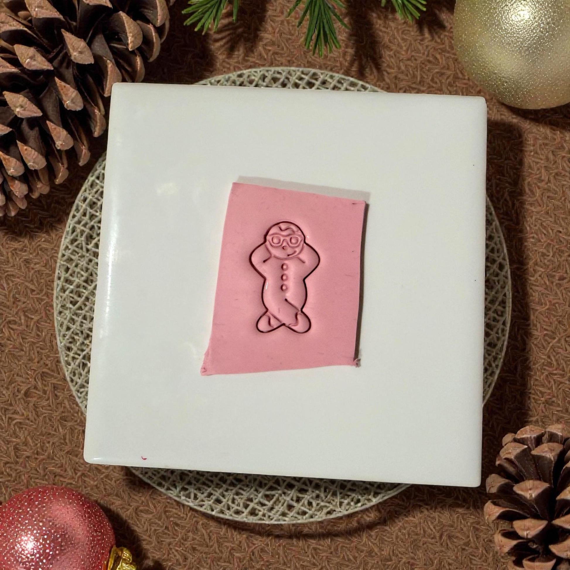 snowman clay imprint on white tile with ornaments