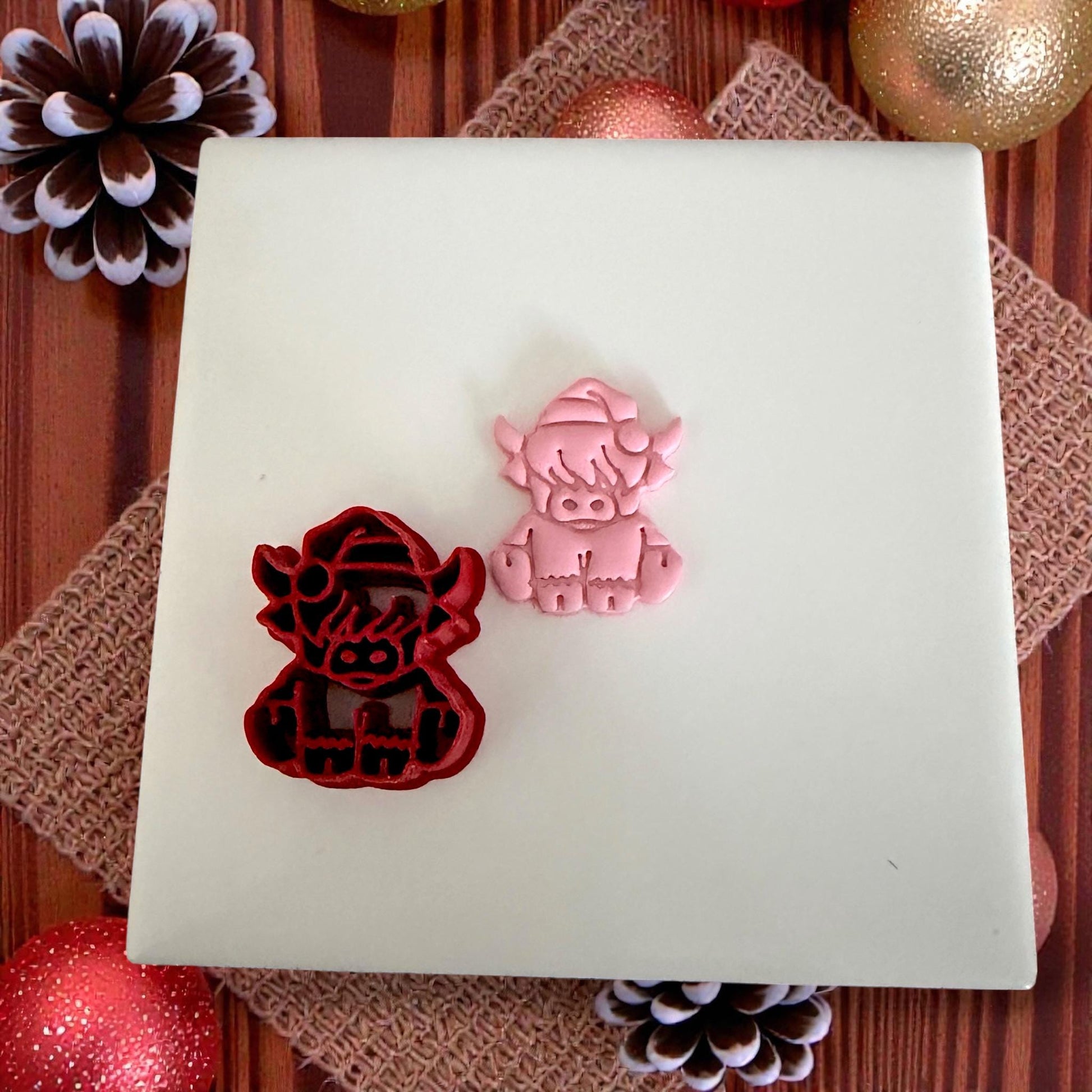 highland cow cutter and clay piece on white tile
