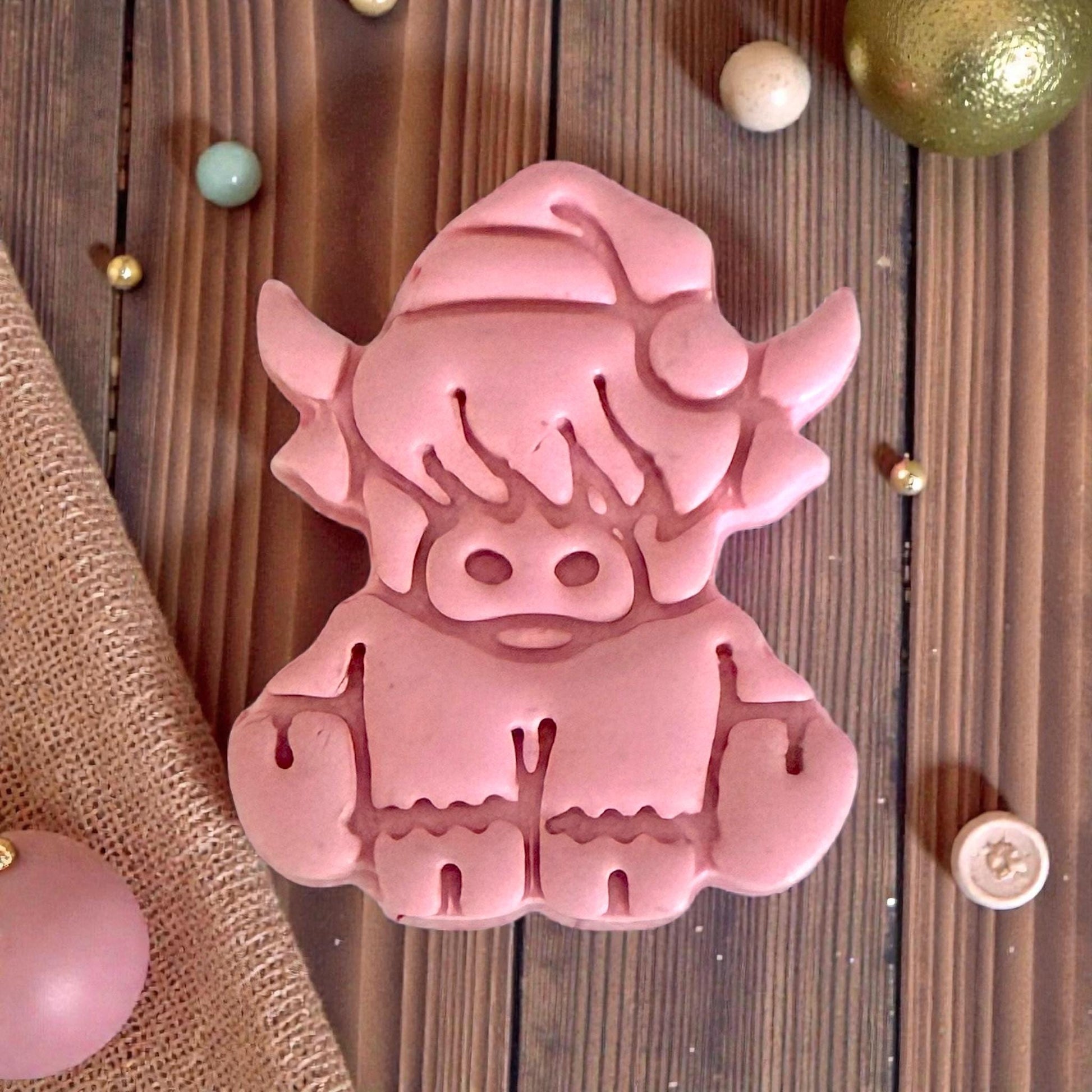 closeup pink clay highland cow impression