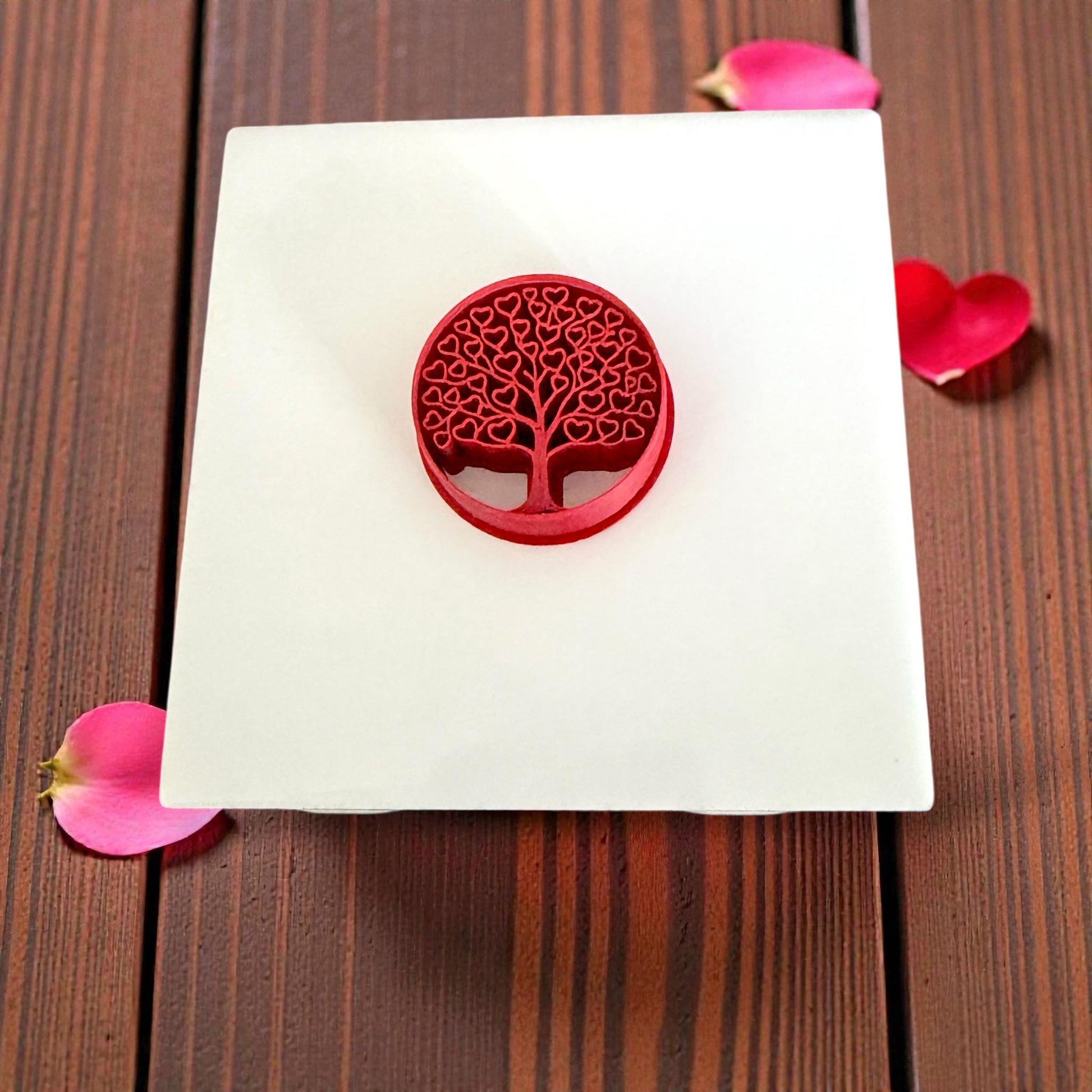 small heart tree clay cutter displayed on white tile