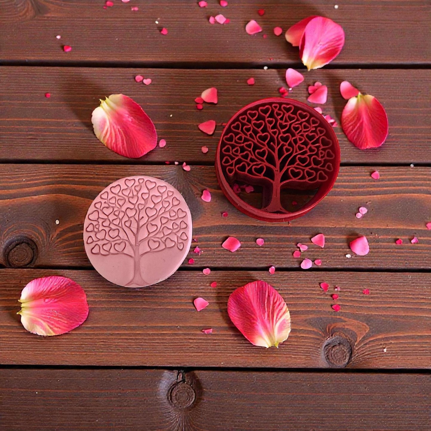 heart tree cutter and pink clay impression on wood