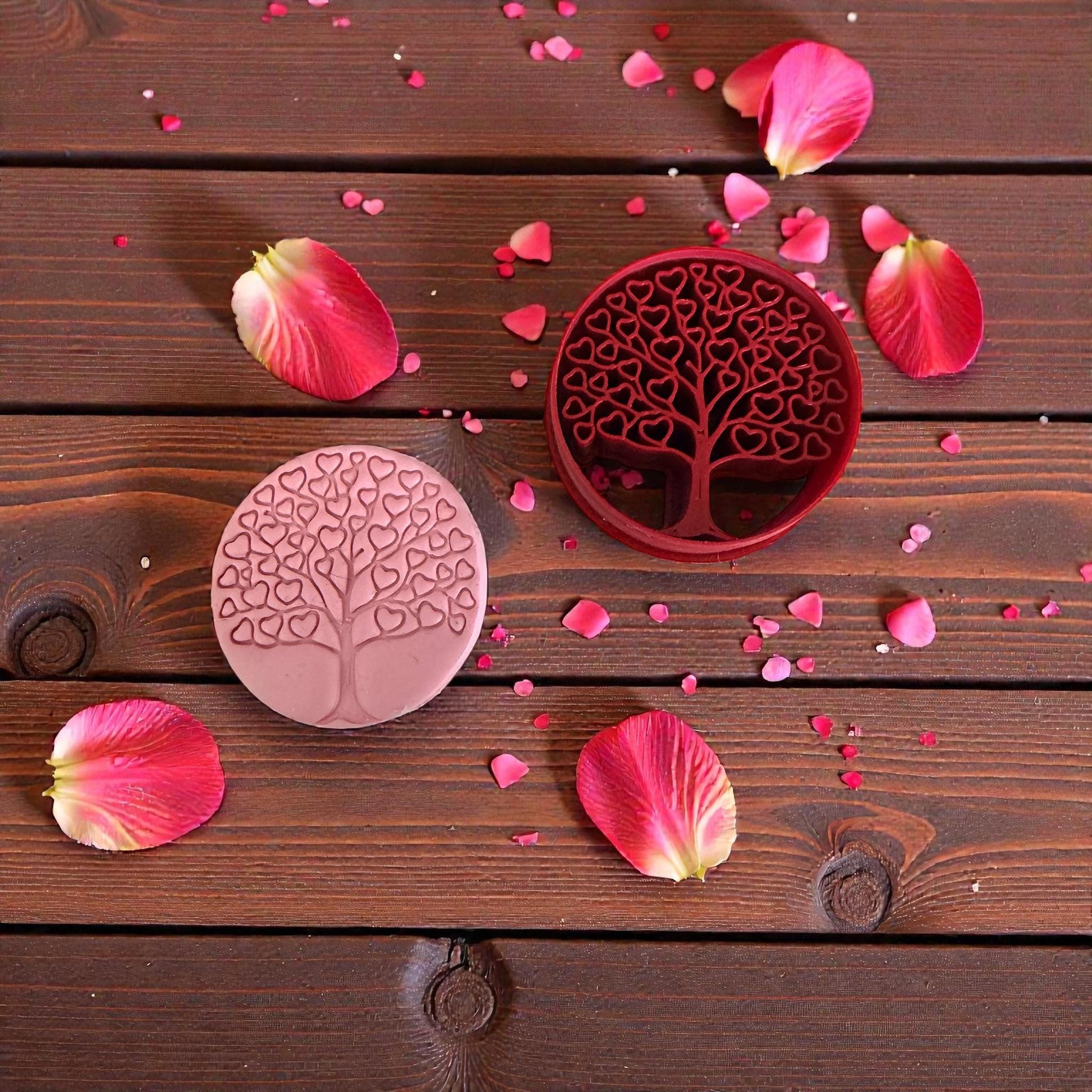 heart tree cutter and pink clay impression on wood