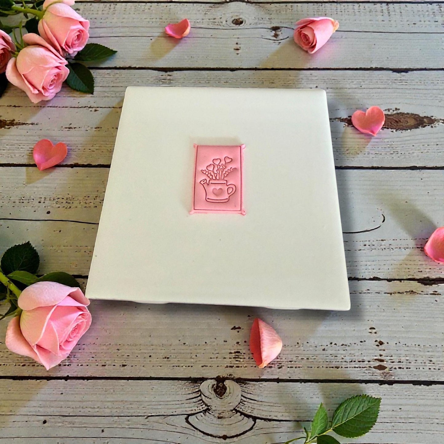 heart bouquet watering can clay impression on white tile