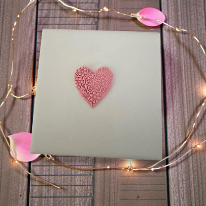 floral butterfly heart clay impression on pink slab