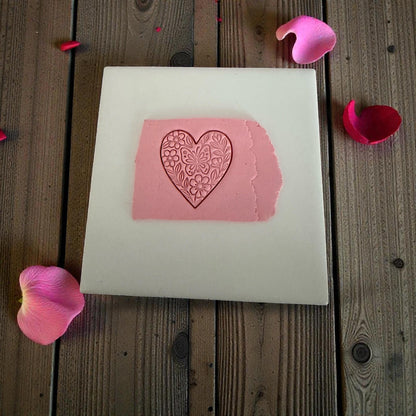 floral butterfly heart clay impression on wooden background with confetti