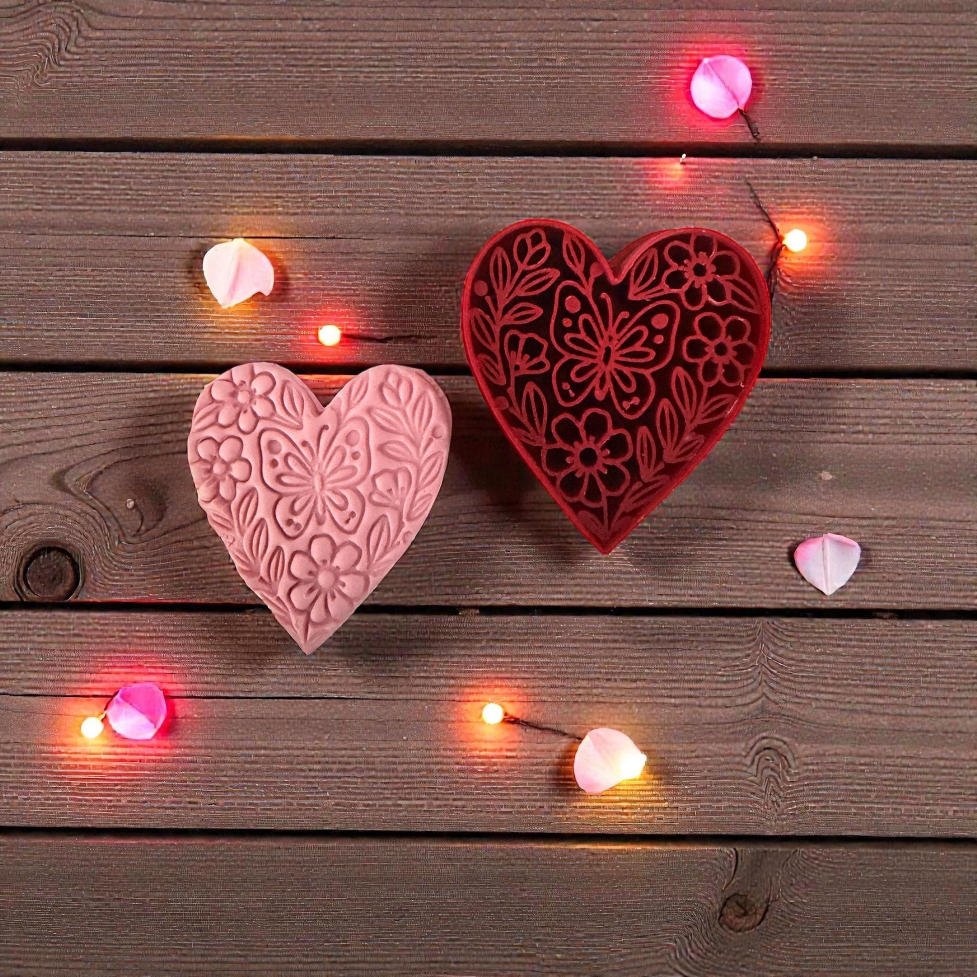 pink floral heart and red heart cutter on wood with lights