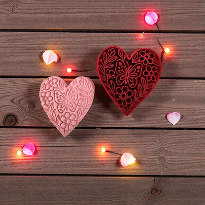 pink floral heart and red heart cutter on wood with lights