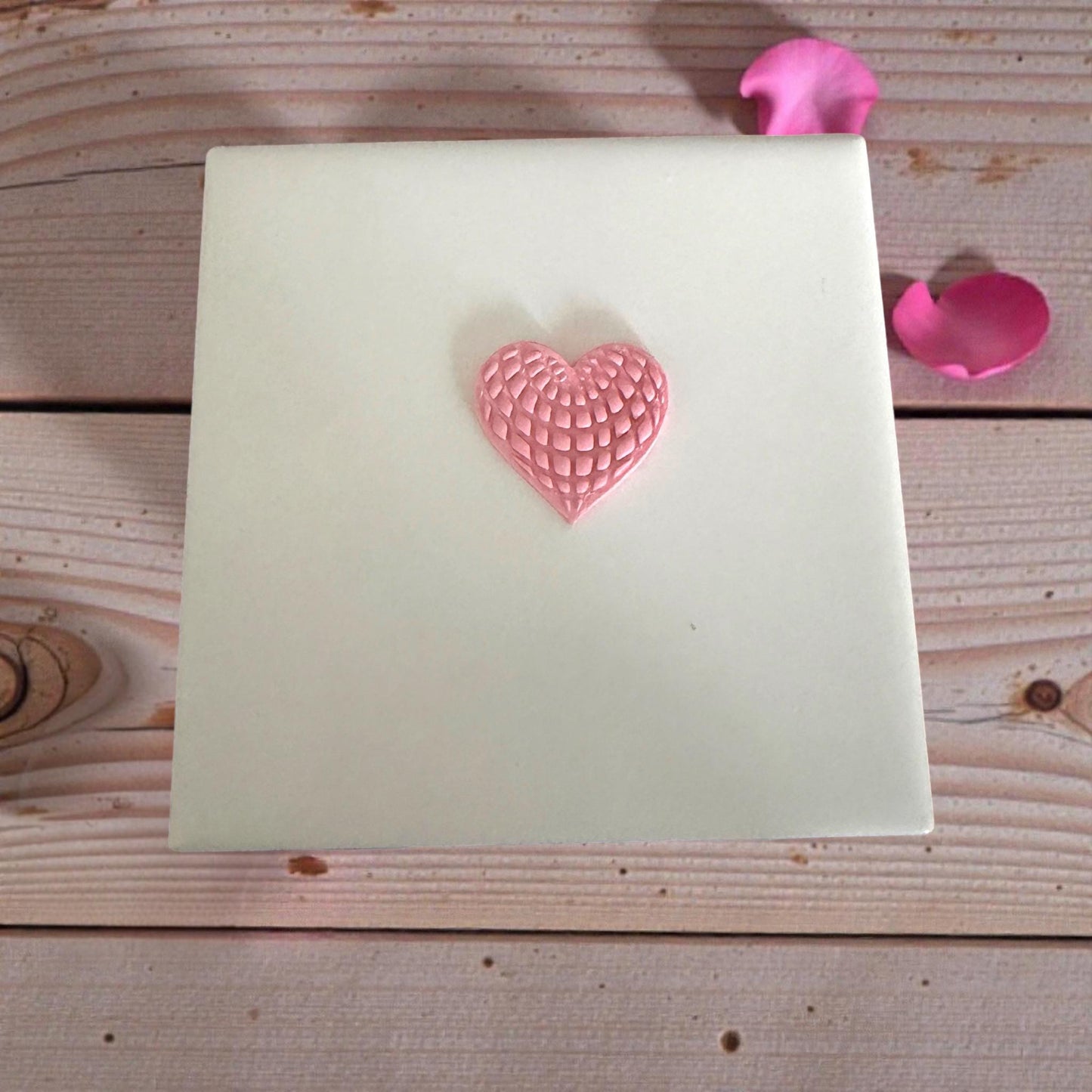 pink textured heart clay imprint on white tile