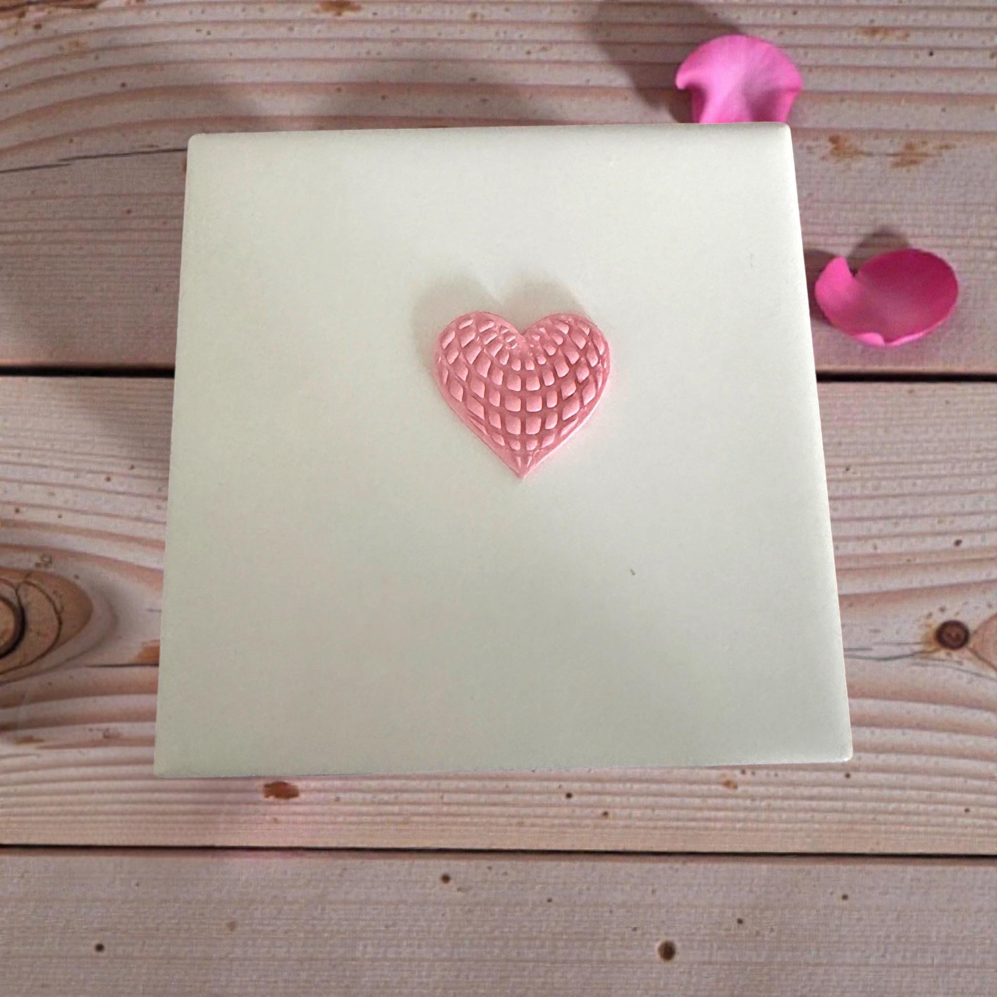 pink textured heart clay imprint on white tile