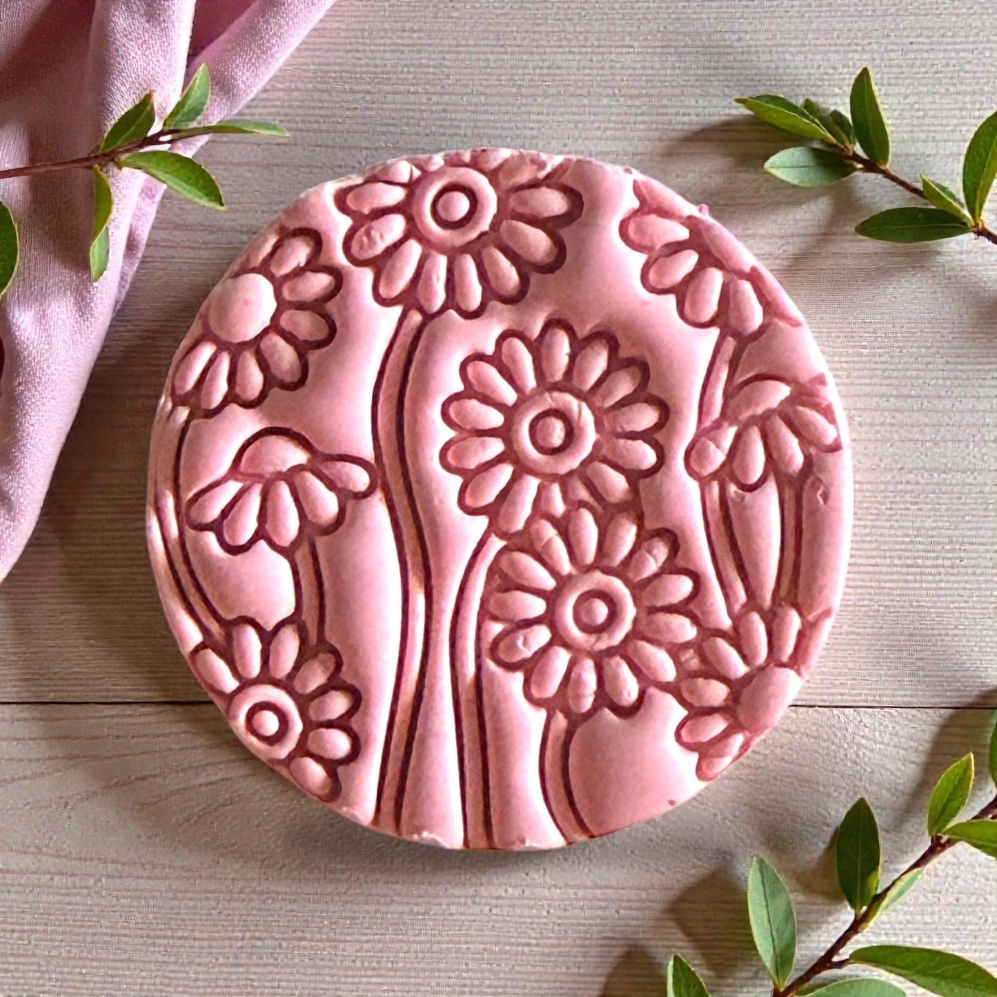 Pink clay daisy field impression with layered floral texture and leaves