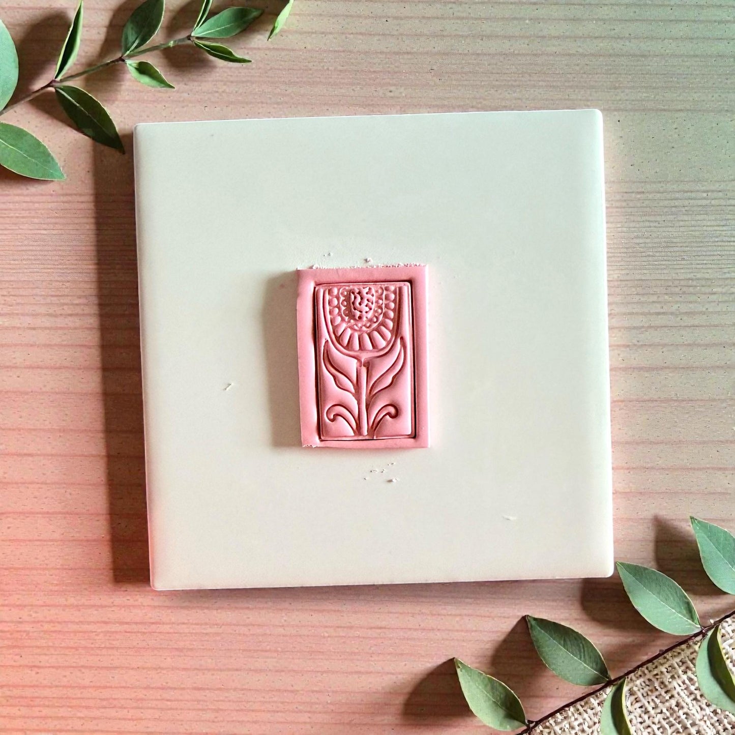 Pink folk floral clay impression with rectangular frame on tile