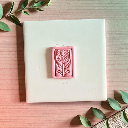 Pink folk floral clay impression with rectangular frame on tile