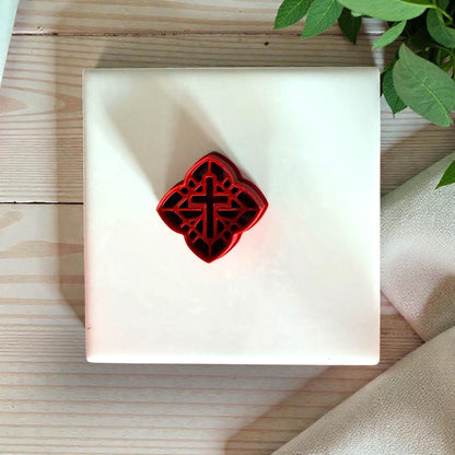 red celtic cross polymer clay cutter on fabric