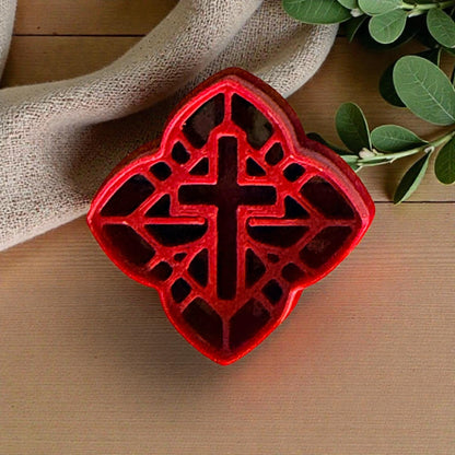 red celtic cross polymer clay cutter on fabric