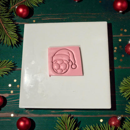 soccer santa hat impression pressed into pink clay slab