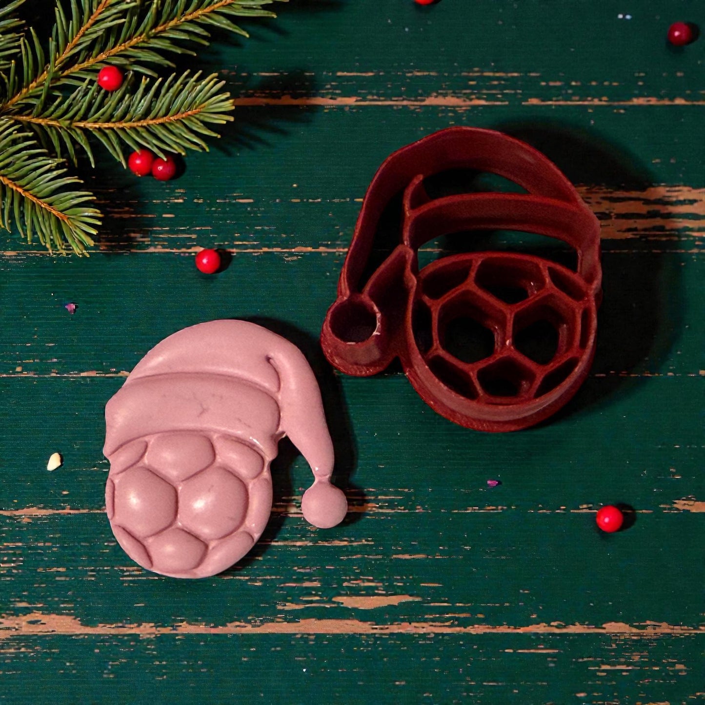 pink soccer ball santa hat impression beside red cutter