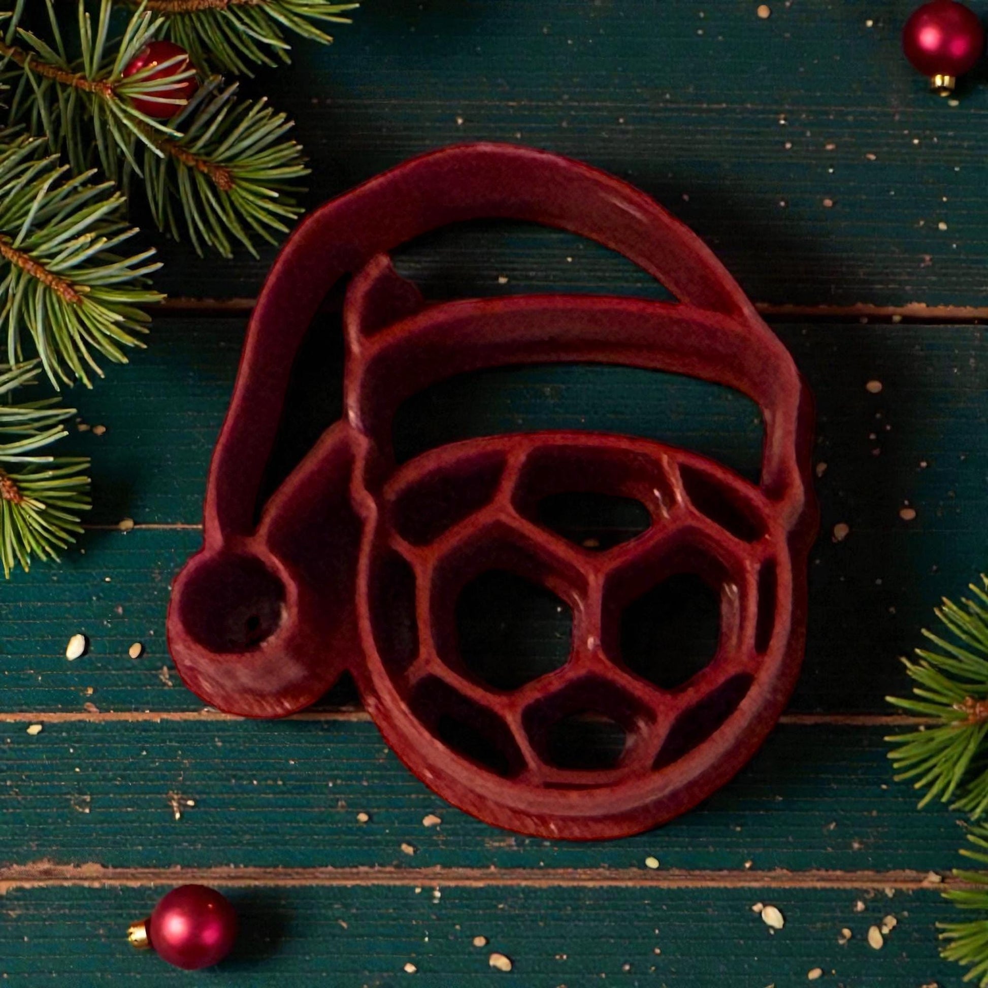 santa hat soccer ball clay cutter on green wood background