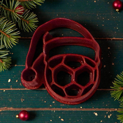 santa hat soccer ball clay cutter on green wood background