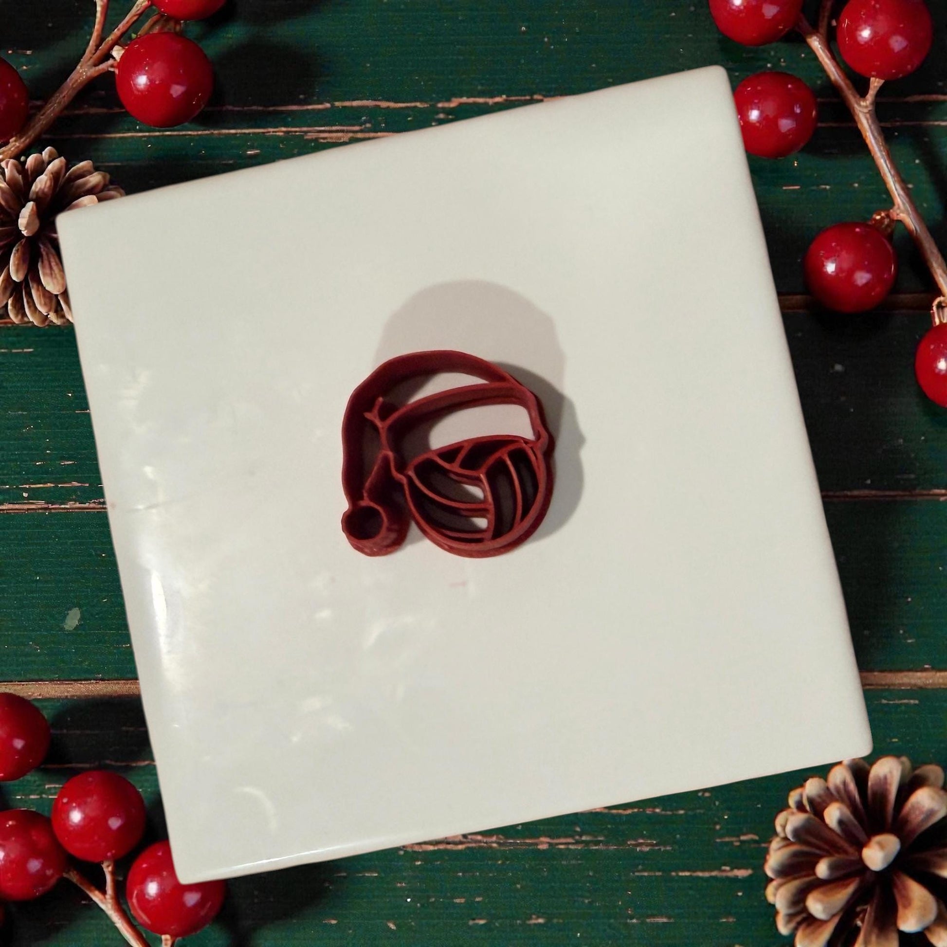 volleyball santa clay cutter sitting on white tile with holiday decor