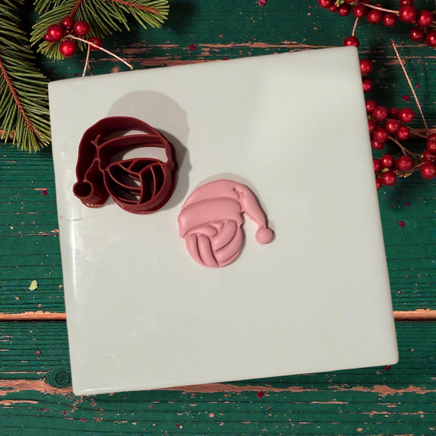 volleyball santa cutter and pink clay impression on white tile