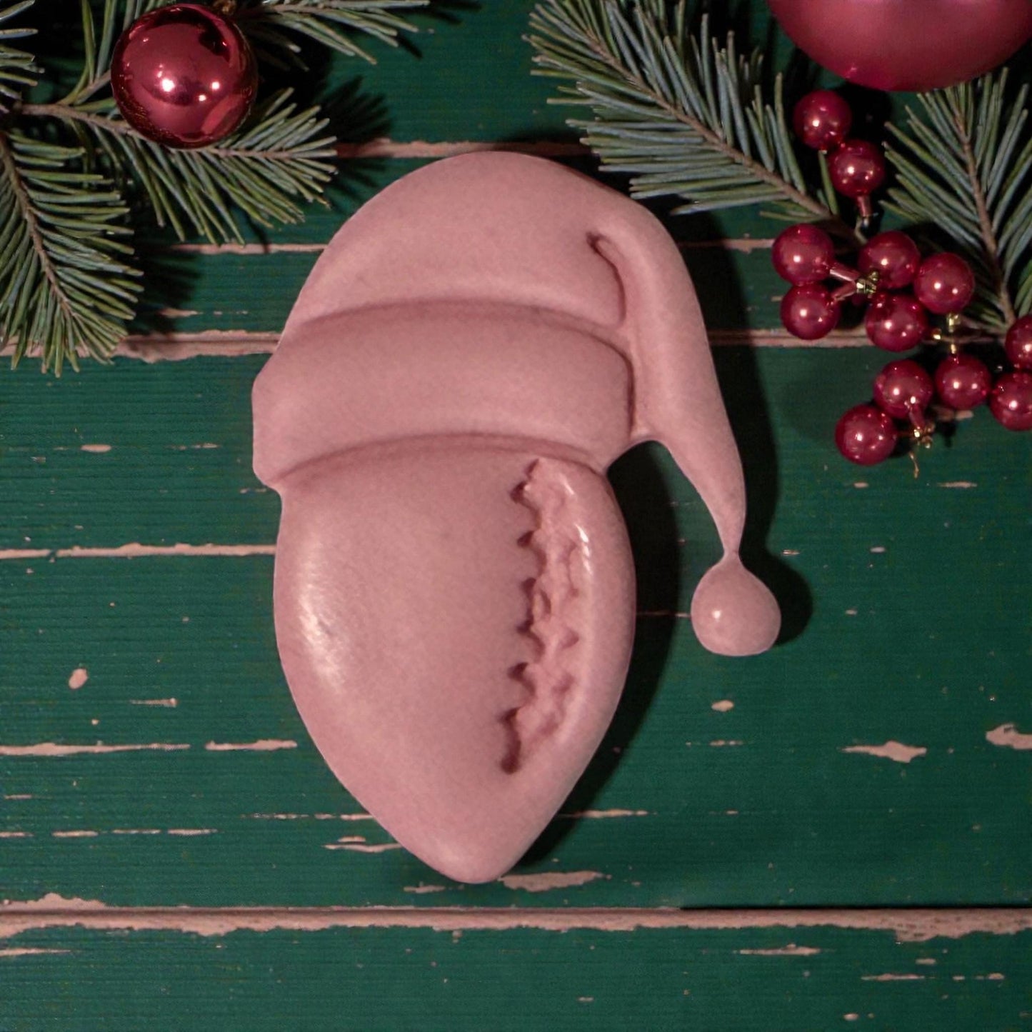 closeup pink football santa clay impression on holiday backdrop