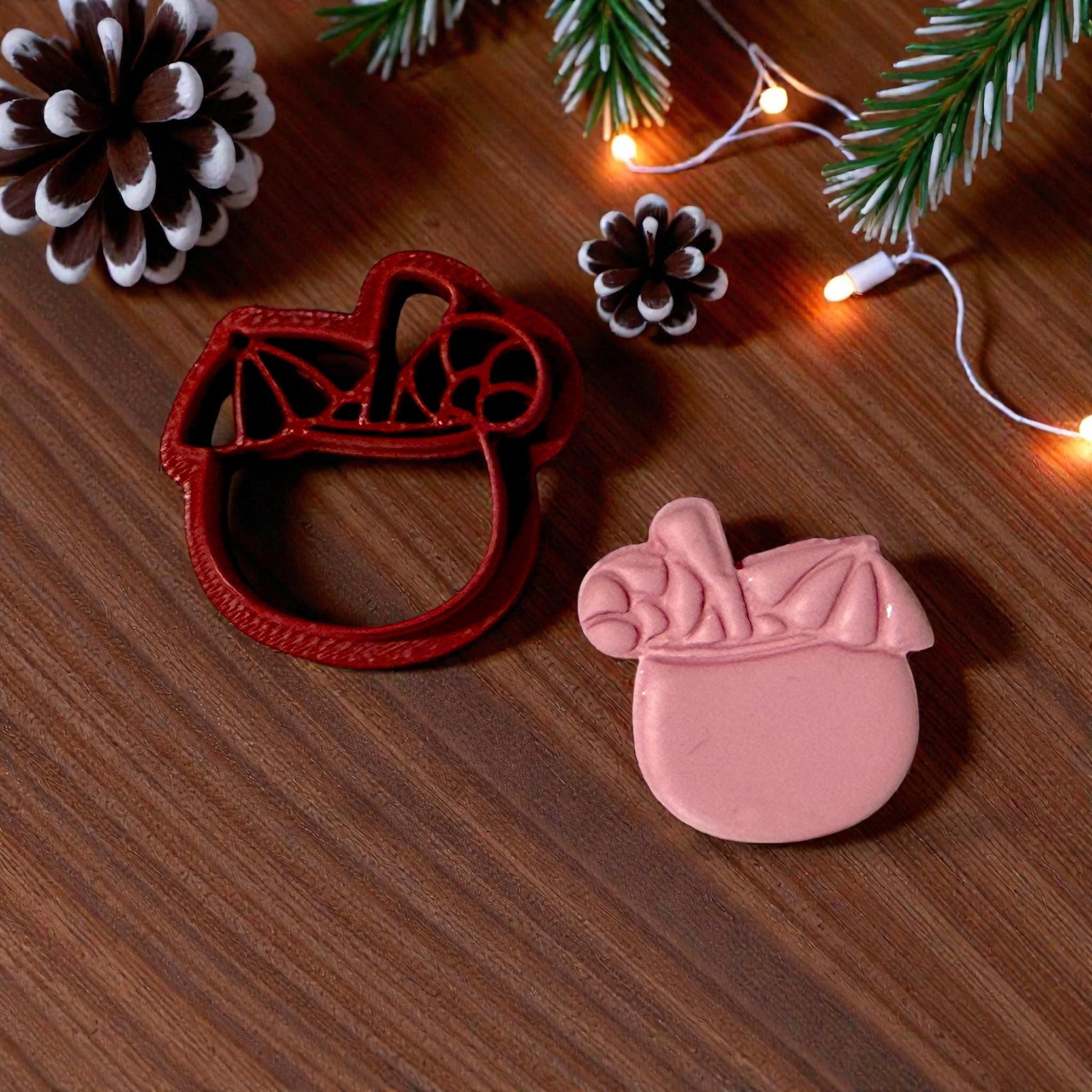 cutter and pink clay coconut drink on wood with pinecones