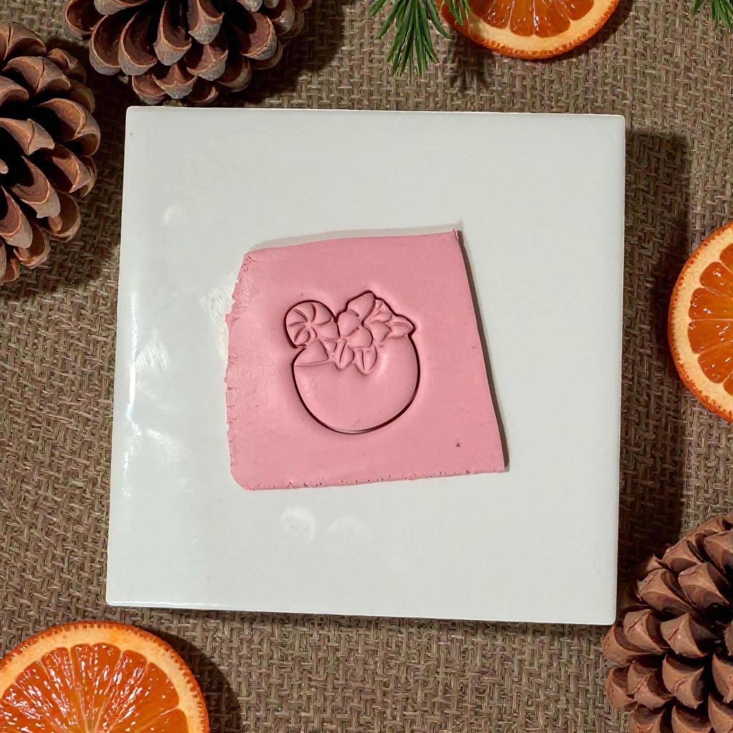 pink clay drink impression with holiday oranges and pinecones