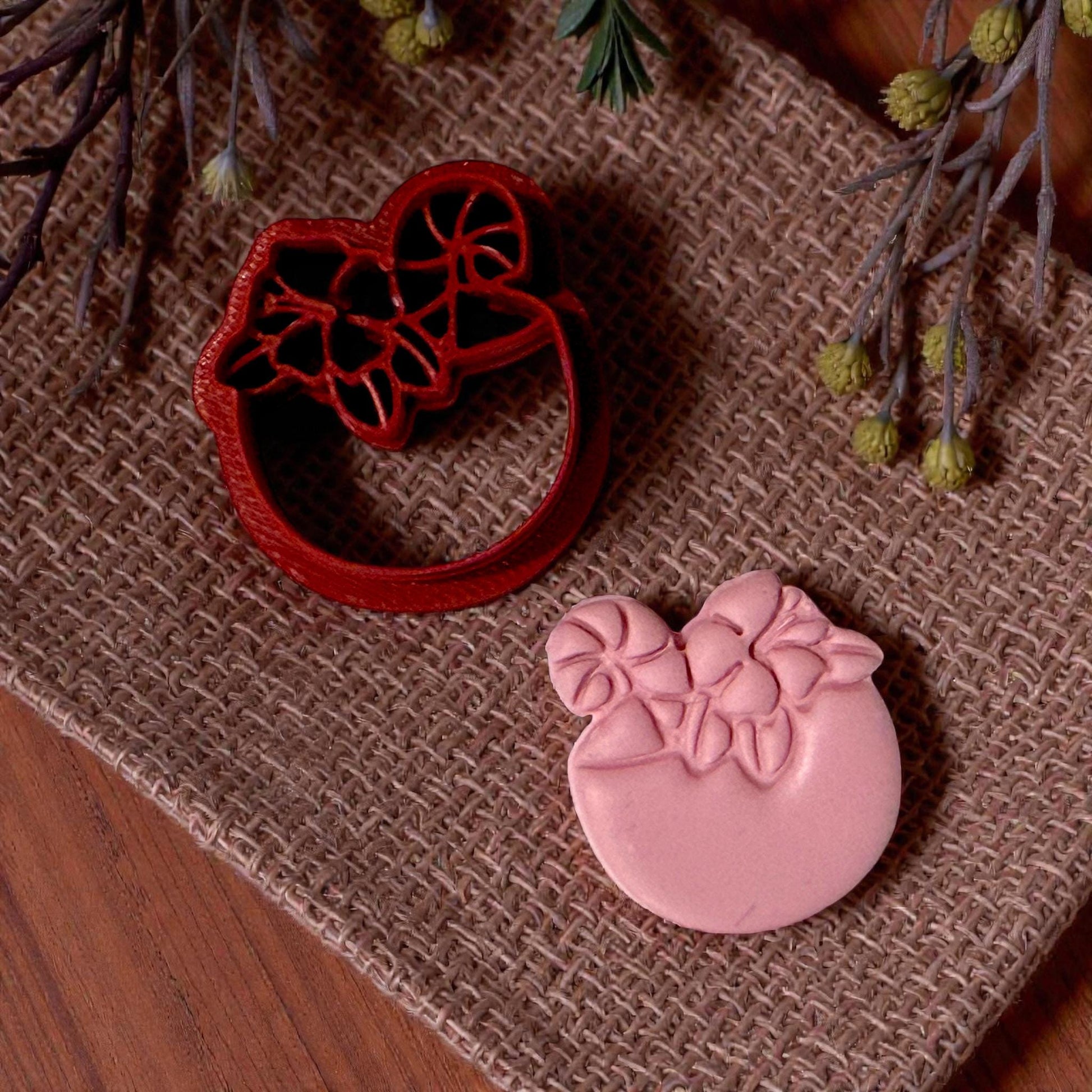 pink clay coconut drink impression on burlap and cutter side by side